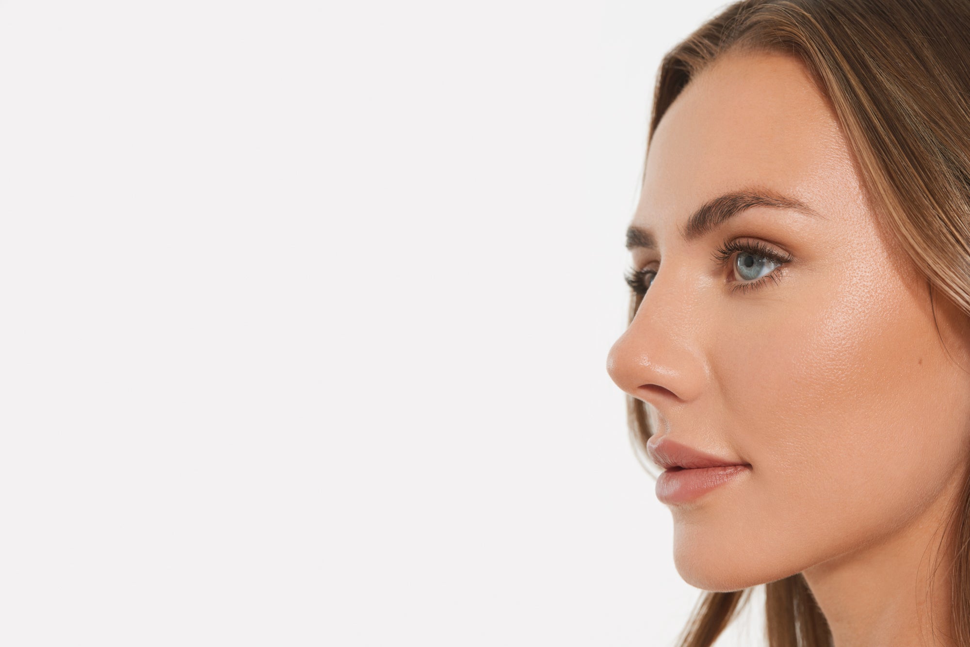 Close-up of a woman's face with permanent makeup, including lip blush and microshading, resulting in a natural and flawless look.